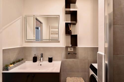 a bathroom with a sink and a mirror at Apartment Vitale in Bologna