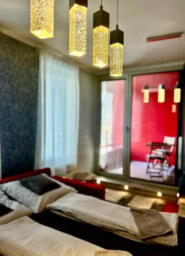 a bedroom with a bed and a window and lights at Apartmánik v tichom nádvorí - free parking in Bratislava