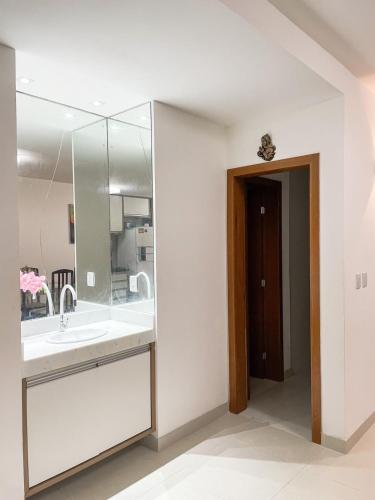 a bathroom with a sink and a mirror at LAZER EM GUARAJUBA in Guarajuba