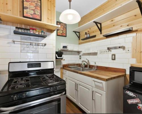 a kitchen with a stove and a sink at Beautiful Studio Apartment in Historic House in New Haven