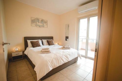 Postel nebo postele na pokoji v ubytování Artemide Apartment
