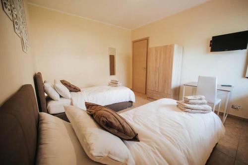 a living room with two beds and a couch at Artemide Apartment in Montepaone Lido