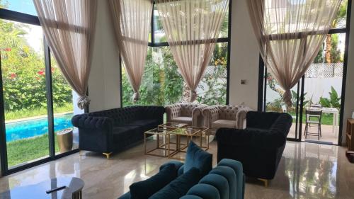 a living room with blue furniture and large windows at Tamares in Casablanca