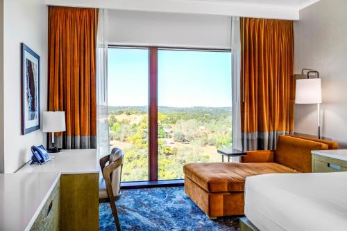 a hotel room with a bed and a large window at Red Hawk Resort & Casino in Placerville