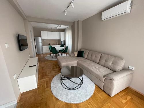 a living room with a couch and a table at Kali Apartments in Bitola