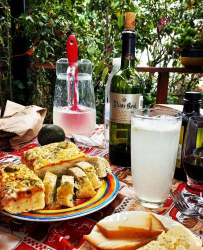 a table with a plate of food and a bottle of wine at Casa Nina in San Cristóbal de Las Casas