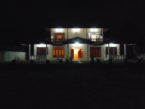 a house lit up at night with lights at Siroma Villa in Bentota