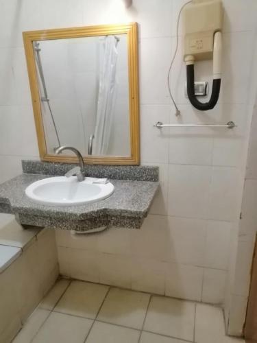 a bathroom with a sink and a mirror at Rezeiky Hotel & Camp in Luxor