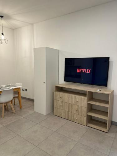 a living room with a television on top of a table at Luxury Apartments in Mendoza