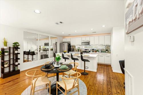 a kitchen and living room with a table and chairs at Luxe 3 Story Townhome with Downtown View Near NRG Stadium Centrally Located Walkable To Popular Restaurants sleeps 8 in Houston