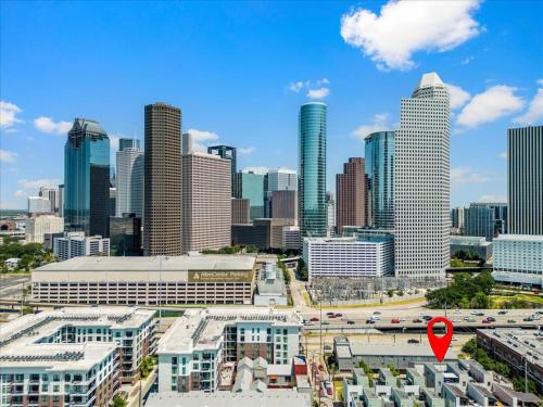 a view of a city skyline with a red marker at Luxe 3 Story Townhome with Downtown View Near NRG Stadium Centrally Located Walkable To Popular Restaurants sleeps 8 in Houston