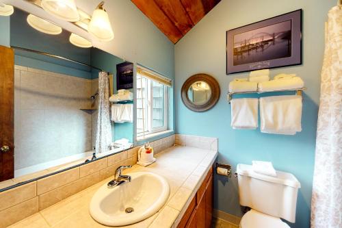 a bathroom with a sink and a toilet and a mirror at Horizon Hideout C202 and 302 in Newport