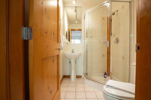 a bathroom with a toilet and a sink and a shower at Bright Multi-Level Home in Whistler
