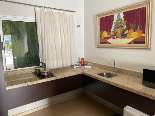 a bathroom with a sink and a window at Porto Center Hotel in Luís Eduardo Magalhães