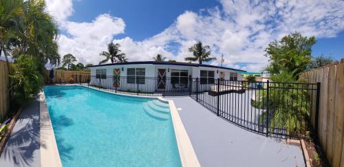 a swimming pool in front of a house at Prime Location-Equipped House W Pool & Patios, Near the Beaches, Ideal for Small Families, Coastal Haven in Fort Lauderdale