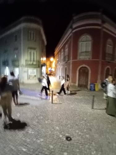 a group of people playing in a street at night at T2 N16 Ref 006 in Tavira