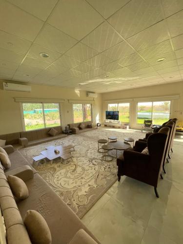 a large living room with a couch and a table at Golden Sands Resort in Qibāʼ
