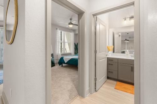 a bathroom with a bed and a sink and a mirror at Perfect Getaway Rentals LLC in Tampa