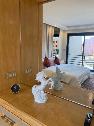 a bedroom with a bed with a mirror and a statue at Incantevole villa Safi Sidi Bouzid near beach in Safi