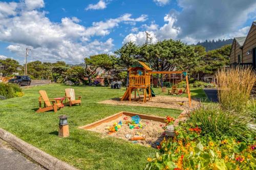 a playground in a yard with a sandbox at Breakers Beach House 1 - Meredith Lodging in Neskowin