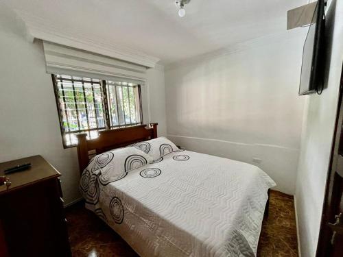 a bedroom with a bed and a window at Best Location near Mayorca Mall Up to 10 guest in Sabaneta