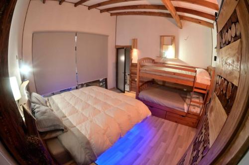 a small bedroom with a bed and a desk at Sendero del Zorro, Km 41,5 ruta N-55 in Chillán