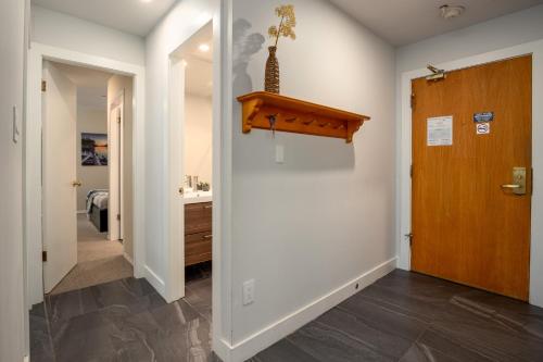 a hallway with a door leading to a bathroom at Great Location with Pool and Hot Tub by Harmony Whistler in Whistler