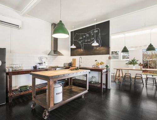 a kitchen with a table and some chairs in a room at Trelawney Farm Mudgee - Rural retreat in Mudgee