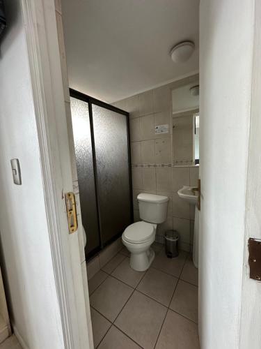 a bathroom with a toilet and a sink at Hotel Mar Sur in Talcahuano