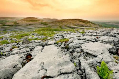 a rocky area with rocks and grass on a mountain at Elegant Lahinch/ Liscannor Cottage 3B 3BR in Liscannor