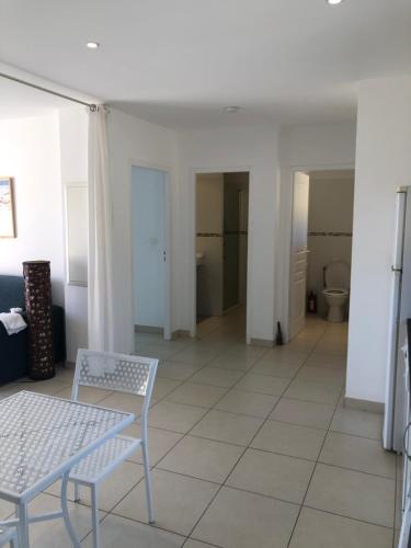a room with a table and chairs and a bathroom at punta di prunetu in Propriano