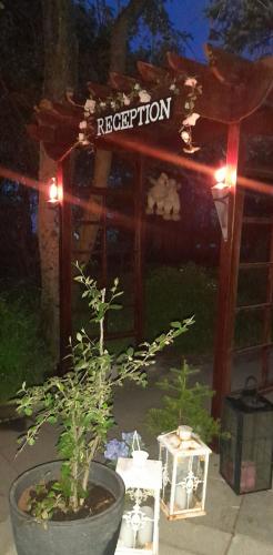 a garden with a house with a sign that says reception at Country Dream - Langholt 2 in Selfoss