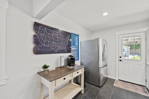 a kitchen with a desk and a refrigerator at Magic Mountain 4 Bedroom 3 Bath Escape Modern Home in Santa Clarita