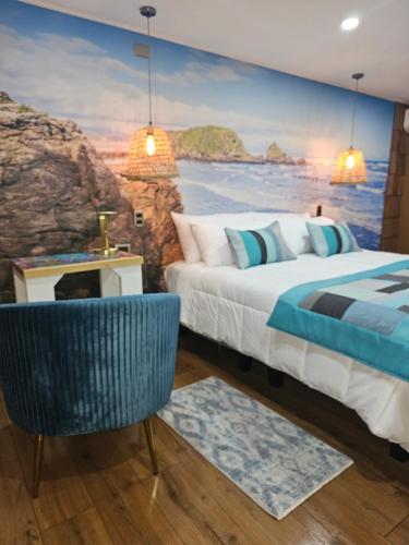 a bedroom with a painting of the ocean at HOTEL BOUTIQUE TIERRA DE ISLAS Chiloé in Castro