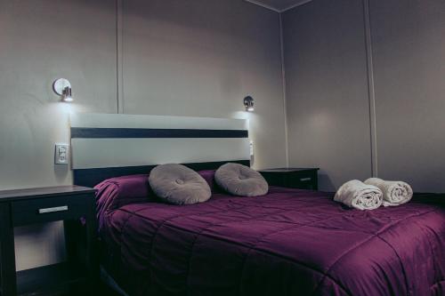 a bedroom with a purple bed with pillows on it at KooColand- XUMUC in Tupungato