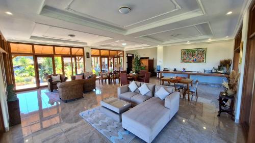 a living room with a couch and a table at Manigelang Villa in Singaraja