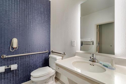 a bathroom with a white toilet and a sink at Fairfield Inn & Suites Cherokee in Cherokee