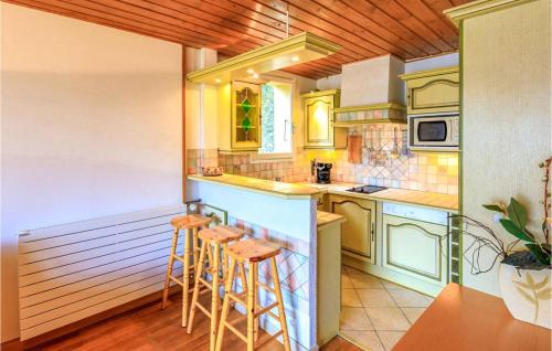 - une cuisine avec un comptoir et des tabourets dans l'établissement 1 Bedroom Lovely Apartment In Orcières, à Orcières