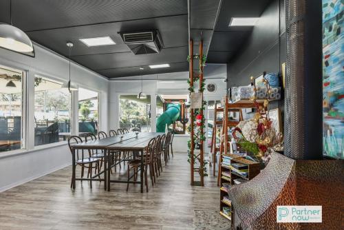 a dining room with a table and chairs at The Oasis Tamworth in Tamworth