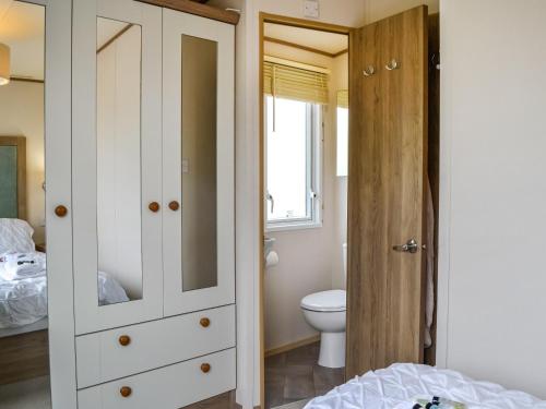 a bathroom with a toilet and a white cabinet at Sea View 14 - Uk45161 in Mainsriddle