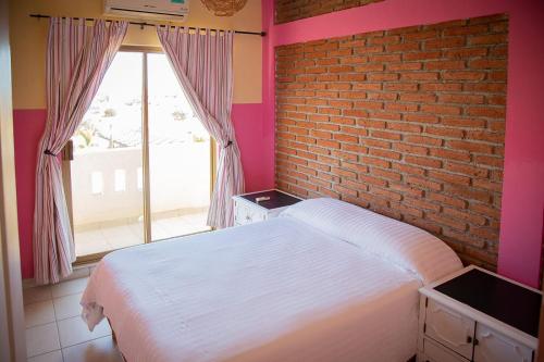 Ein Bett oder Betten in einem Zimmer der Unterkunft Garimar Condominios en San Carlos