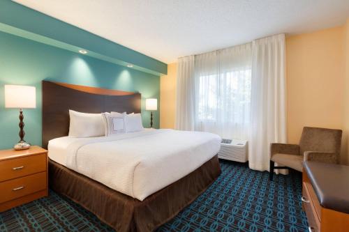 a hotel room with a large bed and a window at Fairfield Inn & Suites Bismarck North in Bismarck