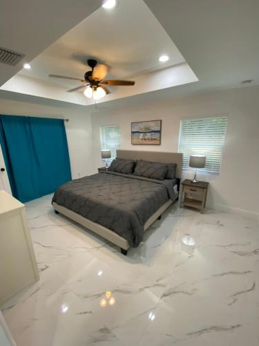 a bedroom with a bed and a ceiling fan at Mango Tree House in Lake Worth