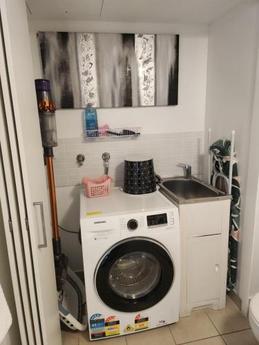 a washing machine in a kitchen with a sink at 1213/146 Sooning street, Nelly Bay, Magnetic Island. Qld 4819. One Bright Point. in Nelly Bay