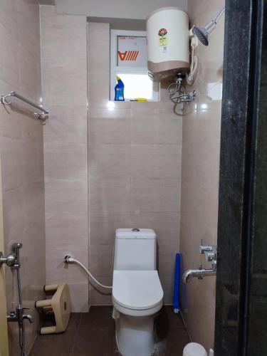 a small bathroom with a toilet and a window at Rahuls castle in Visakhapatnam