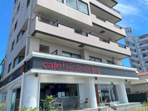 a building with a cafe rock cafe sign in front of it at Support Inn Minami-Chita Annex Hamachaya in Minamichita