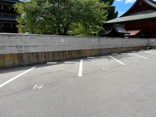 an empty parking lot in front of a building at Thanyaporn Hotel in Takayama