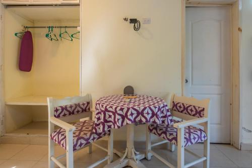 a table with two chairs and a table with a tablecloth at Marysol d11 private beach next to nomads in Isla Mujeres