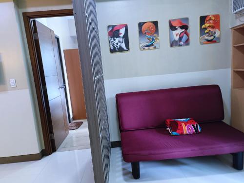 a purple chair with a bag on it in a room at 1BR at TWO PALMTREE VILLAS Across Manila airport terminal 3 in Manila