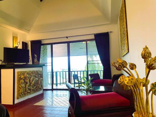 a living room with a couch and a fireplace at Boomerang Village Resort Kata in Kata Beach
